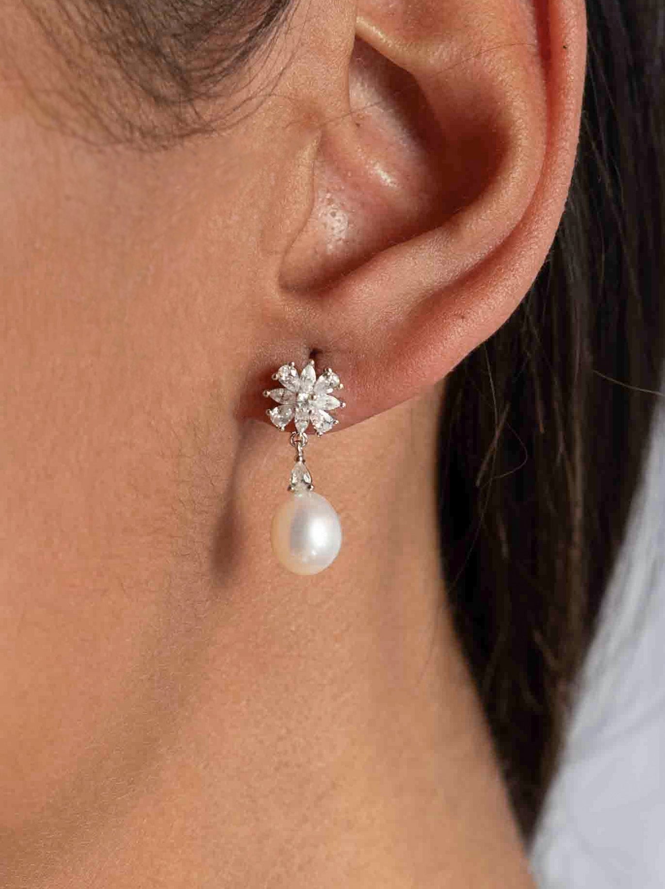 Pendientes de plata con perla puestos, vista lateral