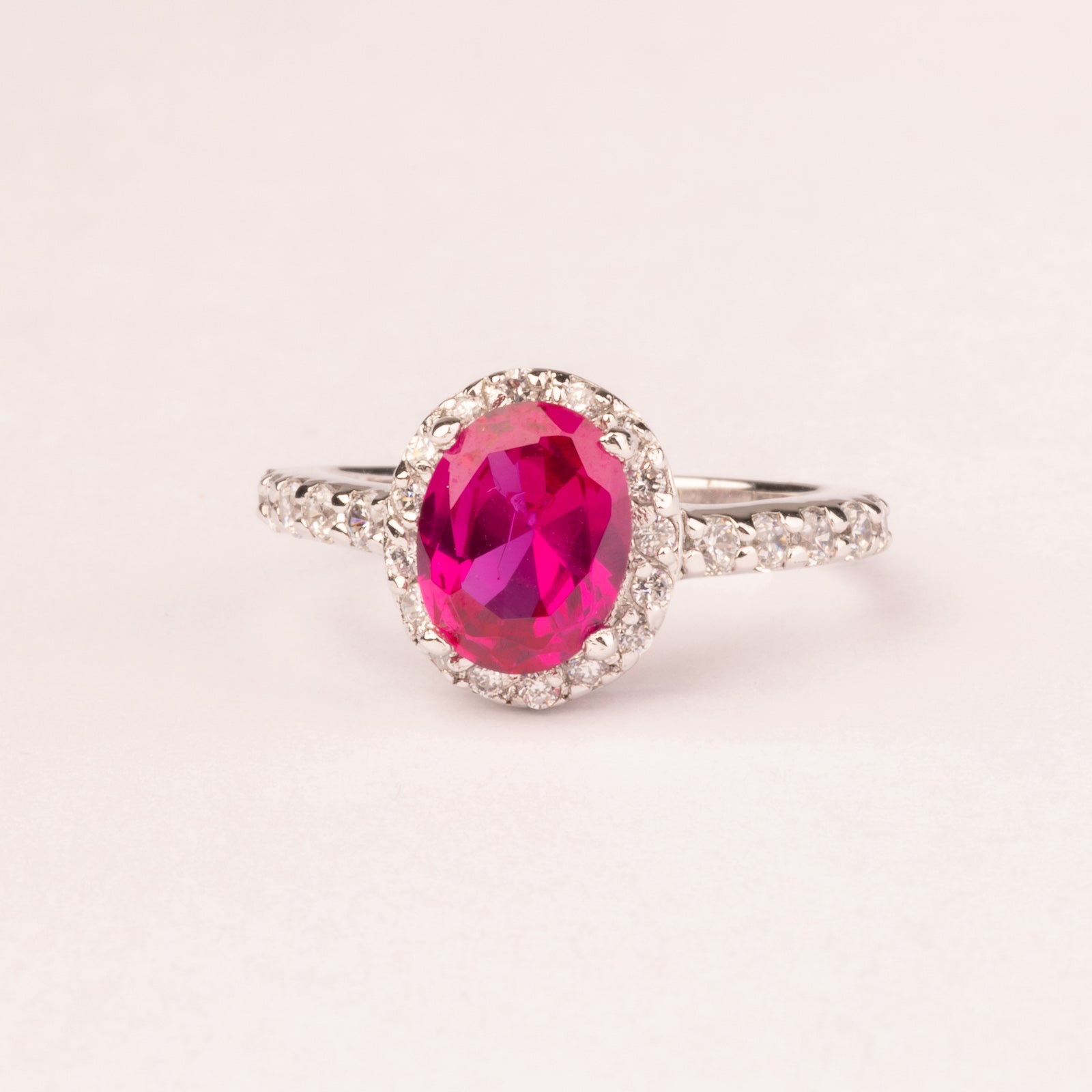 Oval ruby cubic zirconia ring with micro cubic zirconias.