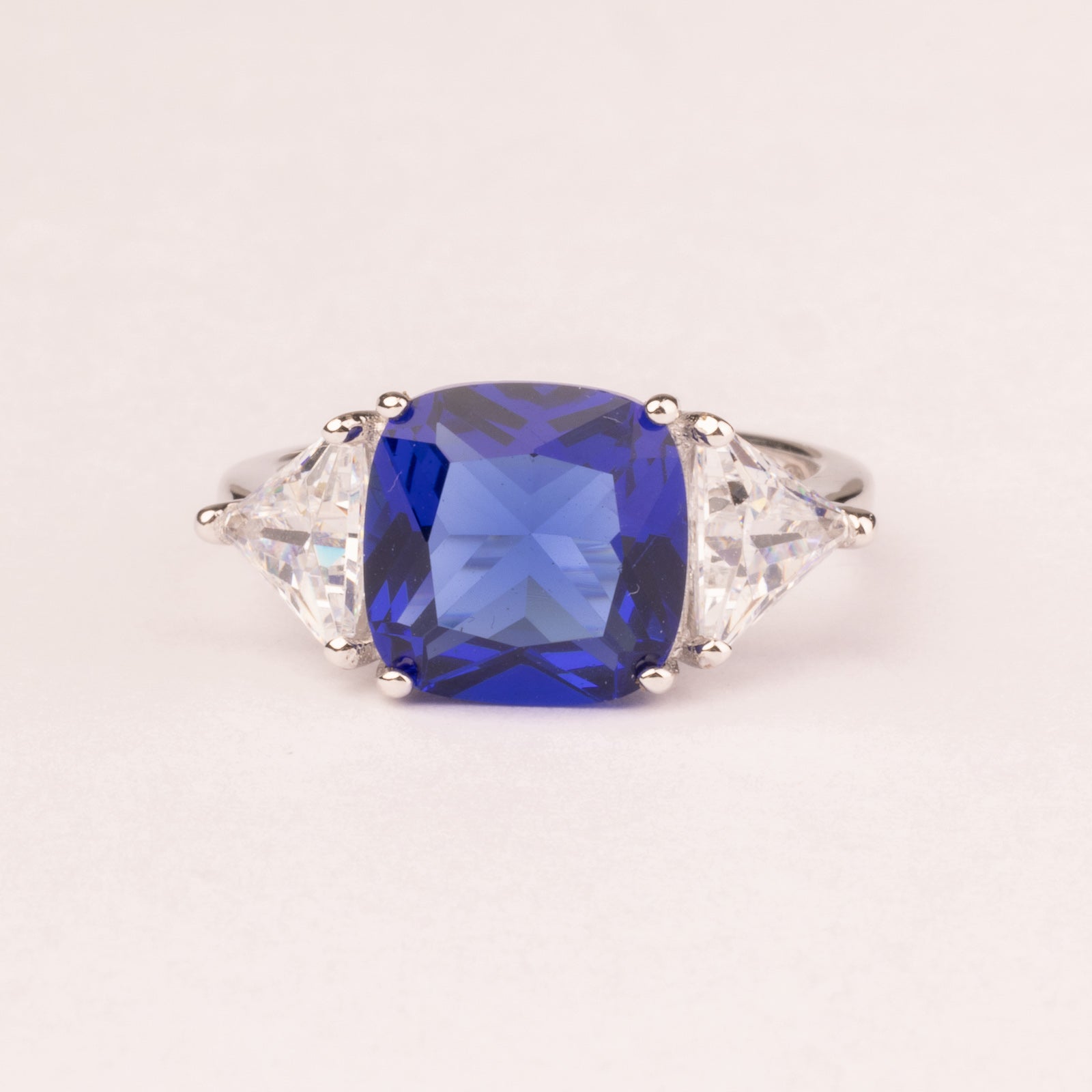 Square sapphire ring with triangular cubic zirconia