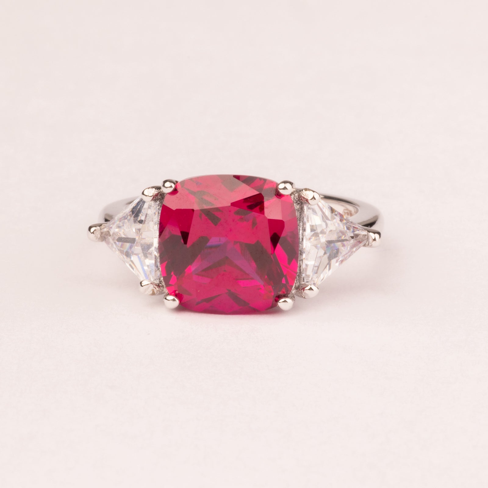 Square ruby ring with triangular cubic zirconia