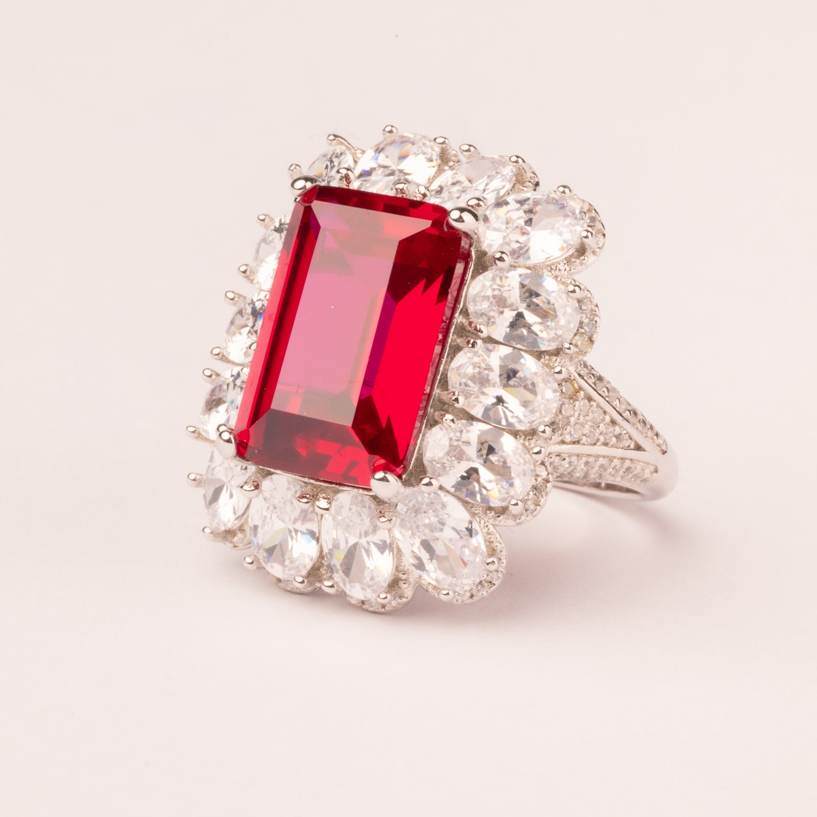 Emerald cut ruby stone ring with pavé
