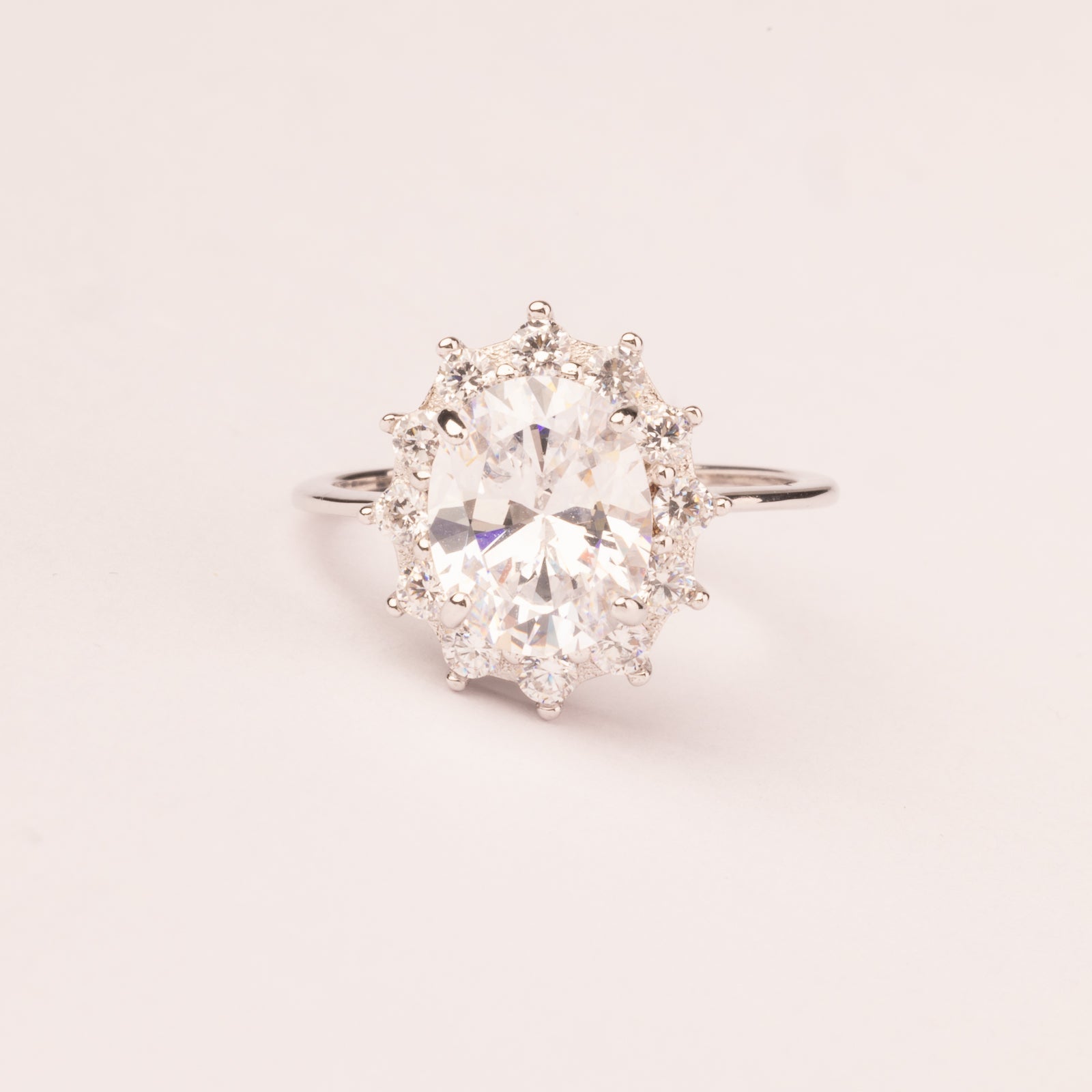 White oval cubic zirconia ring with crown
