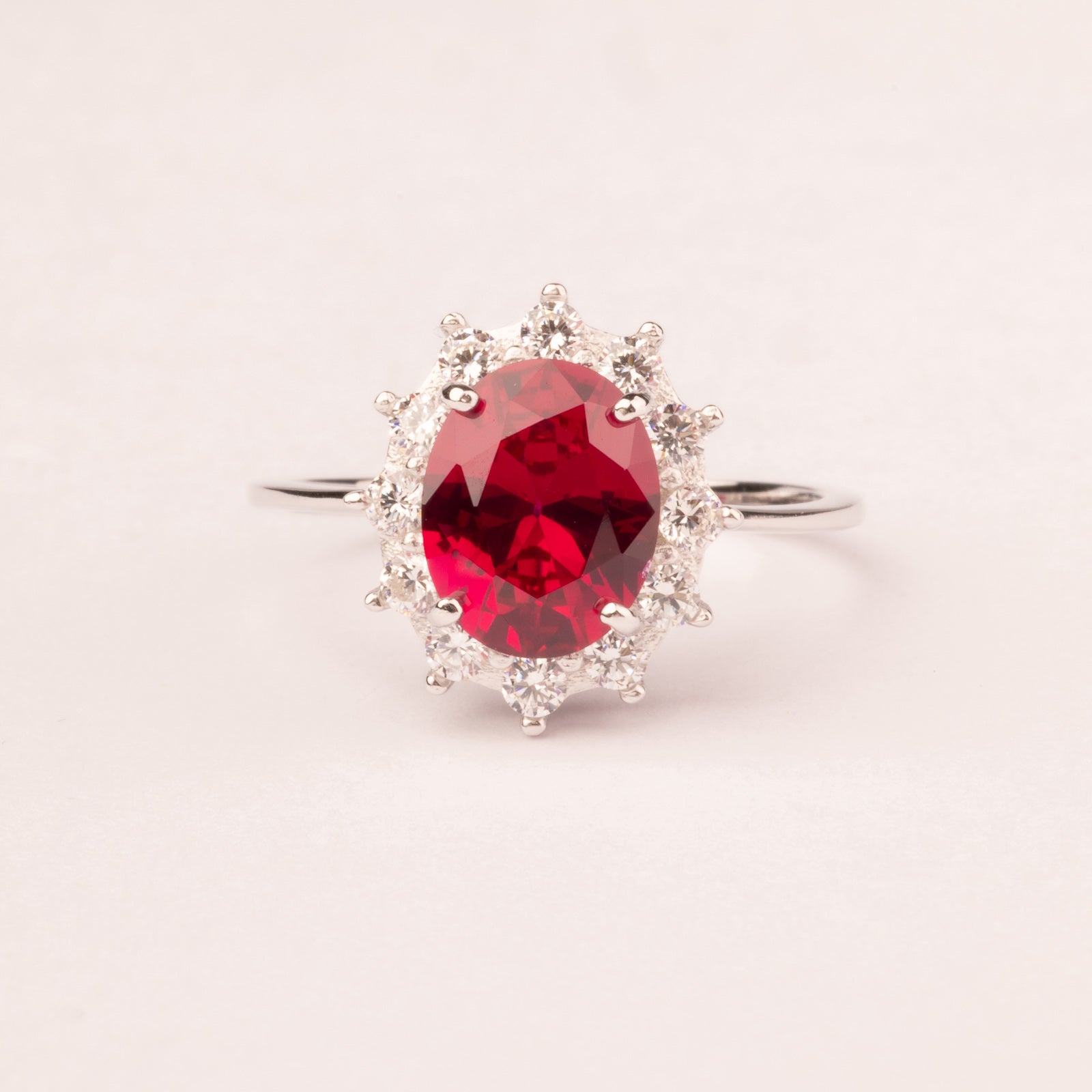Oval ruby cubic zirconia ring with white cubic zirconia crown
