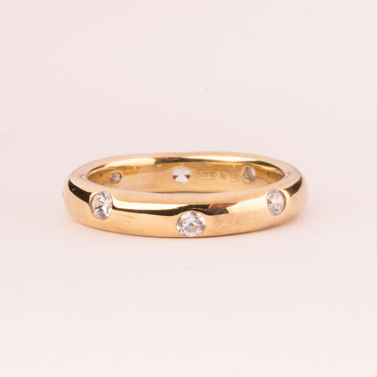 Smooth ring with white cubic zirconia plated in 18k gold
