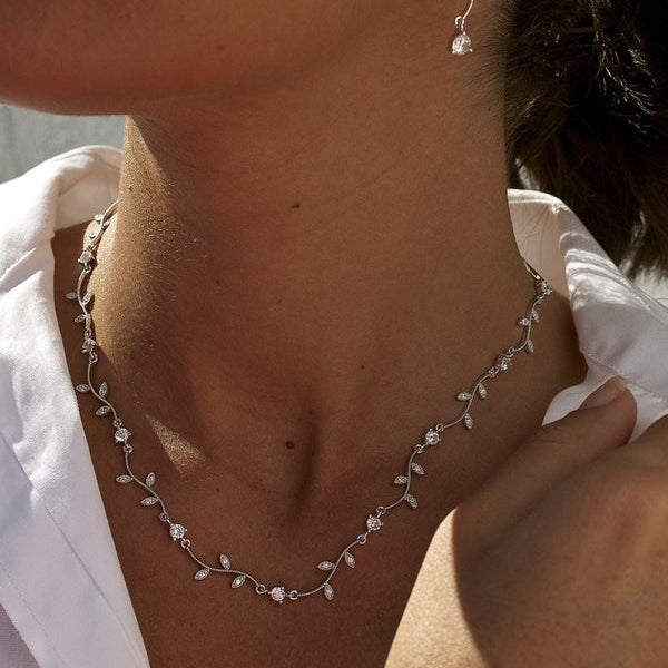 Party necklaces with curvilinear floral design and zirconia