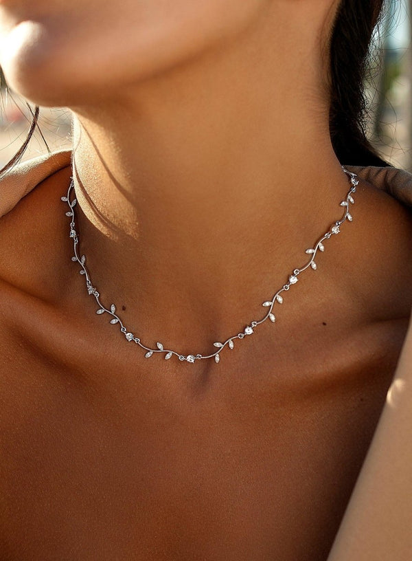 Party necklaces with curvilinear floral design and zirconia