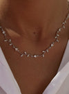 Party necklaces with curvilinear floral and zirconia design
