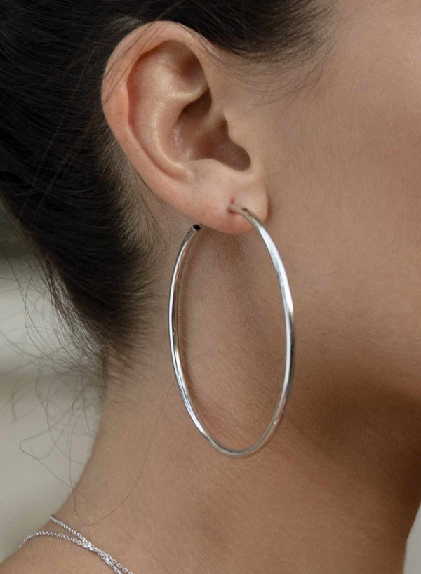 Large hoop earrings with smooth silver tubular design and hidden clasp 60 mm