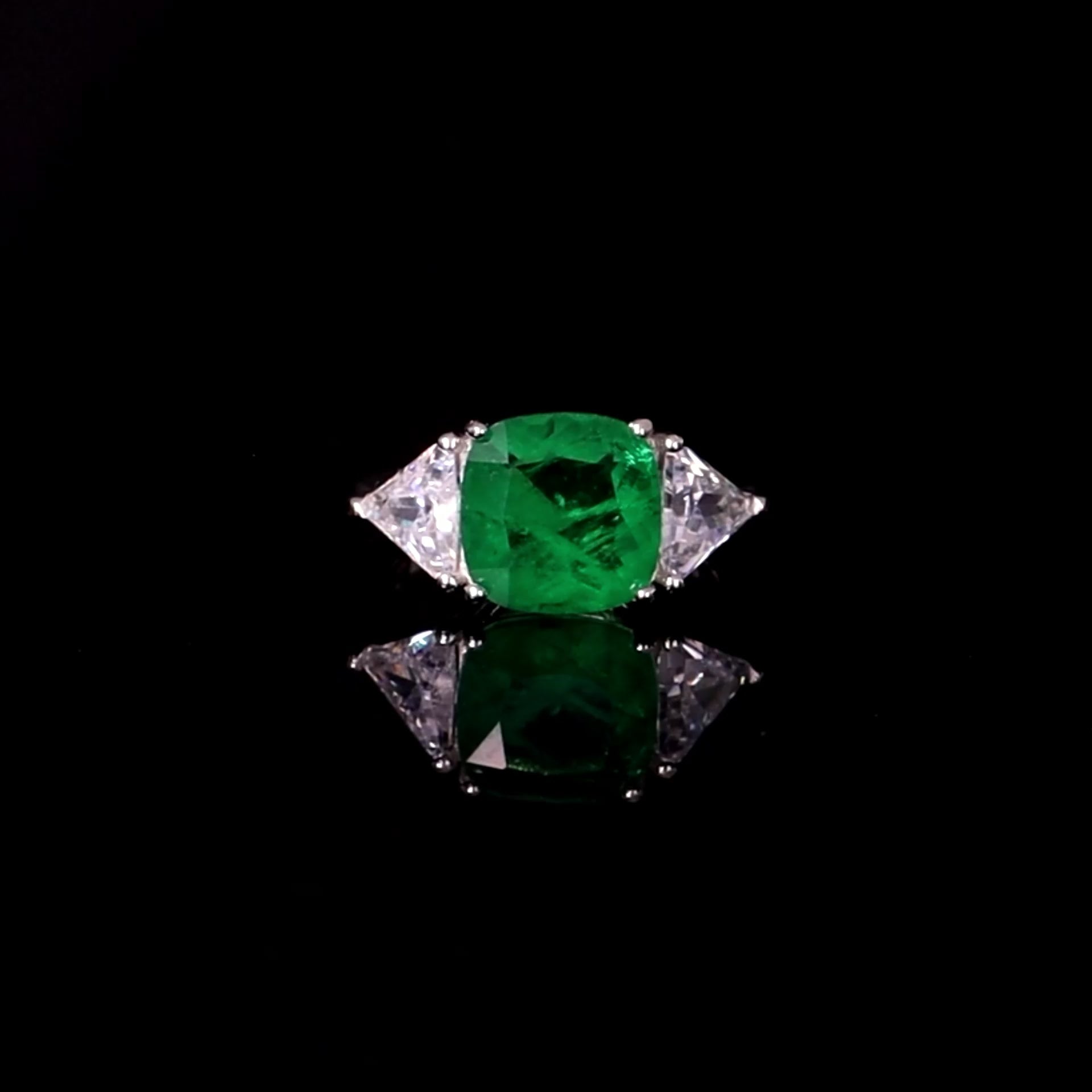 Square emerald ring with triangular zirconia