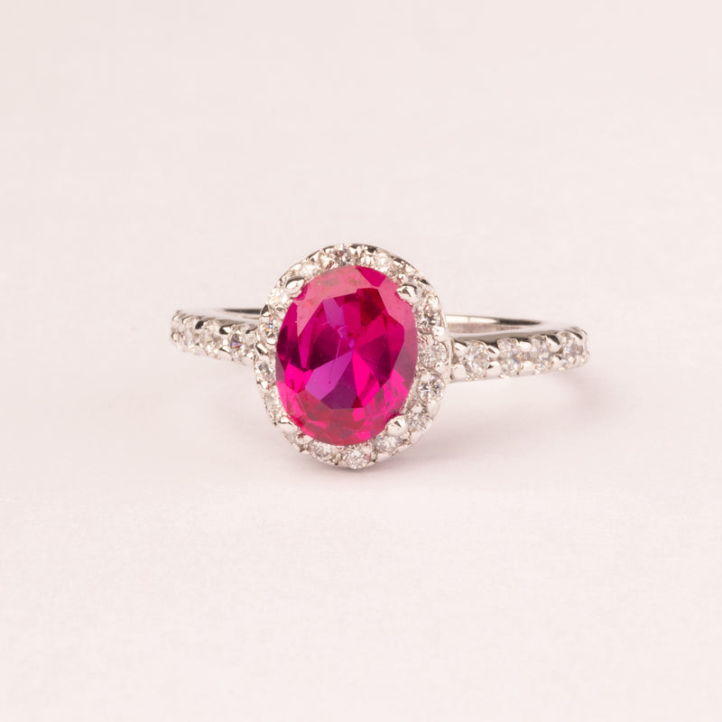 Oval ruby ​​zirconia ring with micro zircons.