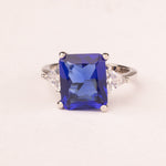 Ring with emerald cut sapphire zircons
