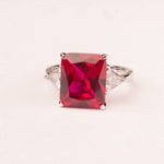 Ring with emerald cut ruby ​​zircons