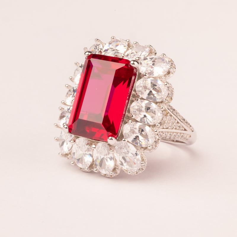 Emerald cut ruby ​​and pavé stone ring